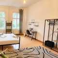How often are the private rooms cleaned and maintained in a coliving space?